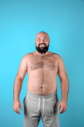 Fat man on color background. Weight loss