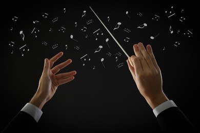 Image of Conductor with baton and music notes on dark background, closeup