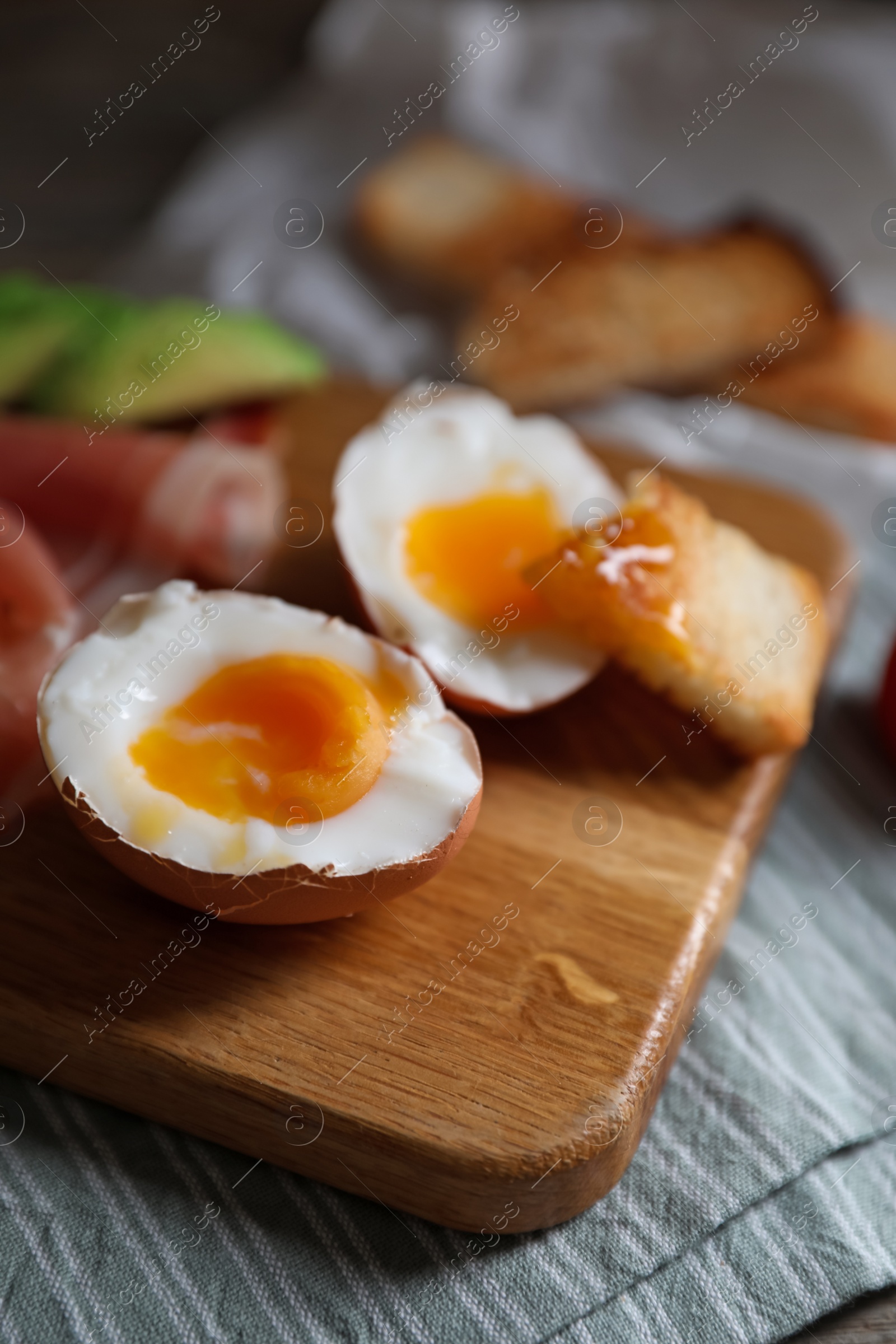 Photo of Delicious breakfast with soft boiled egg on wooden table