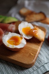 Delicious breakfast with soft boiled egg on wooden table