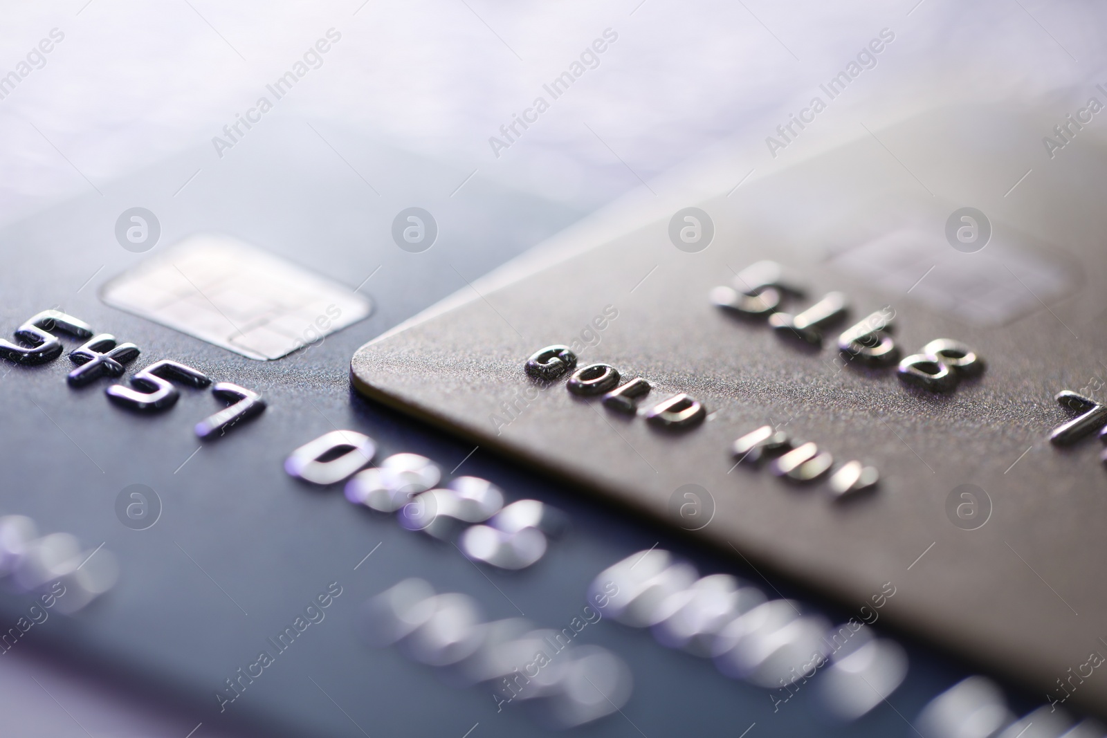 Photo of Plastic credit cards on table, macro view. Color toned