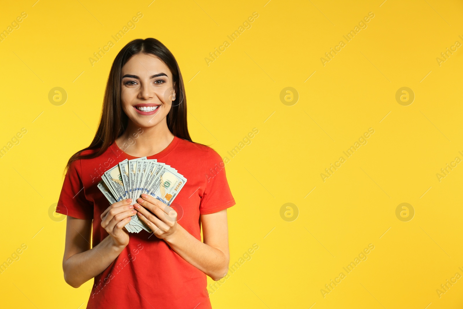 Photo of Young woman with money on color background. Space for text