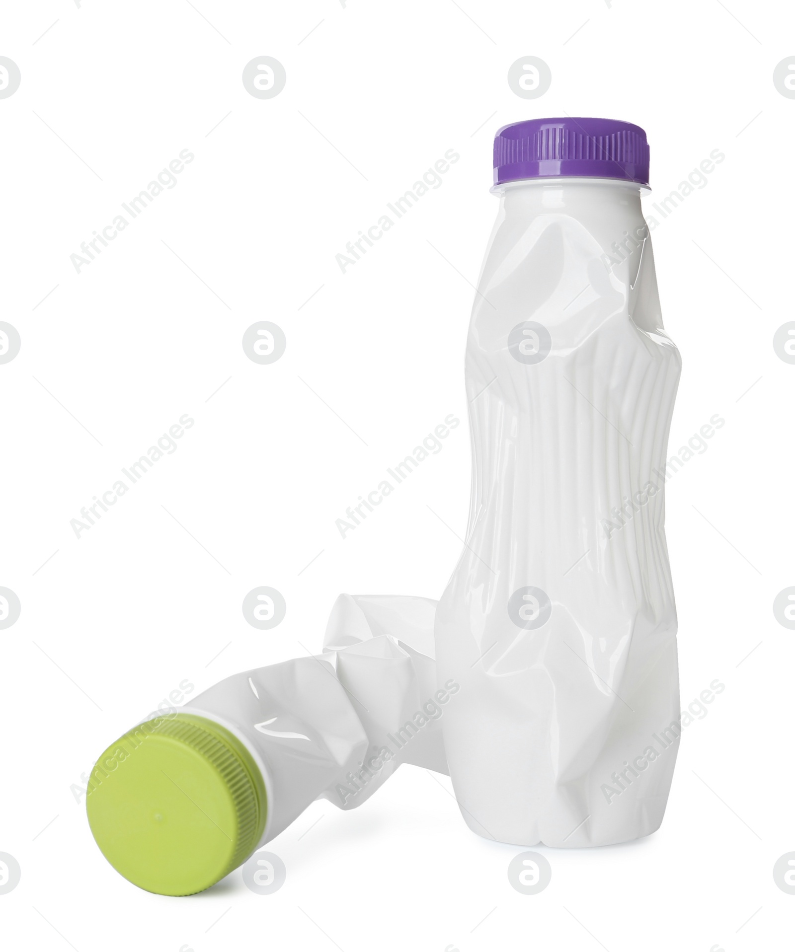 Photo of Crumpled disposable plastic bottles on white background