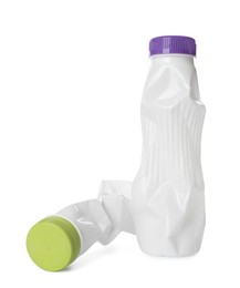 Photo of Crumpled disposable plastic bottles on white background