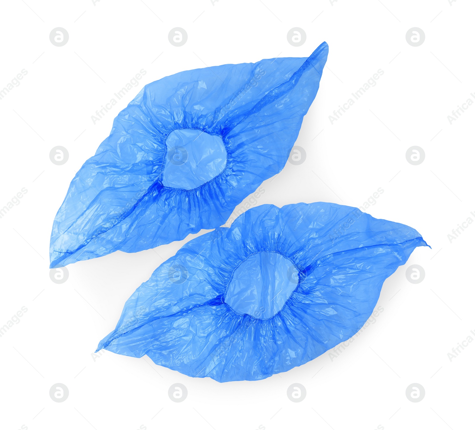 Photo of Pair of blue medical shoe covers isolated on white, top view