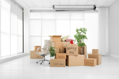 Pile of moving boxes in empty room