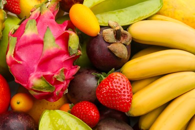 Photo of Assortment of fresh exotic fruits as background, top view