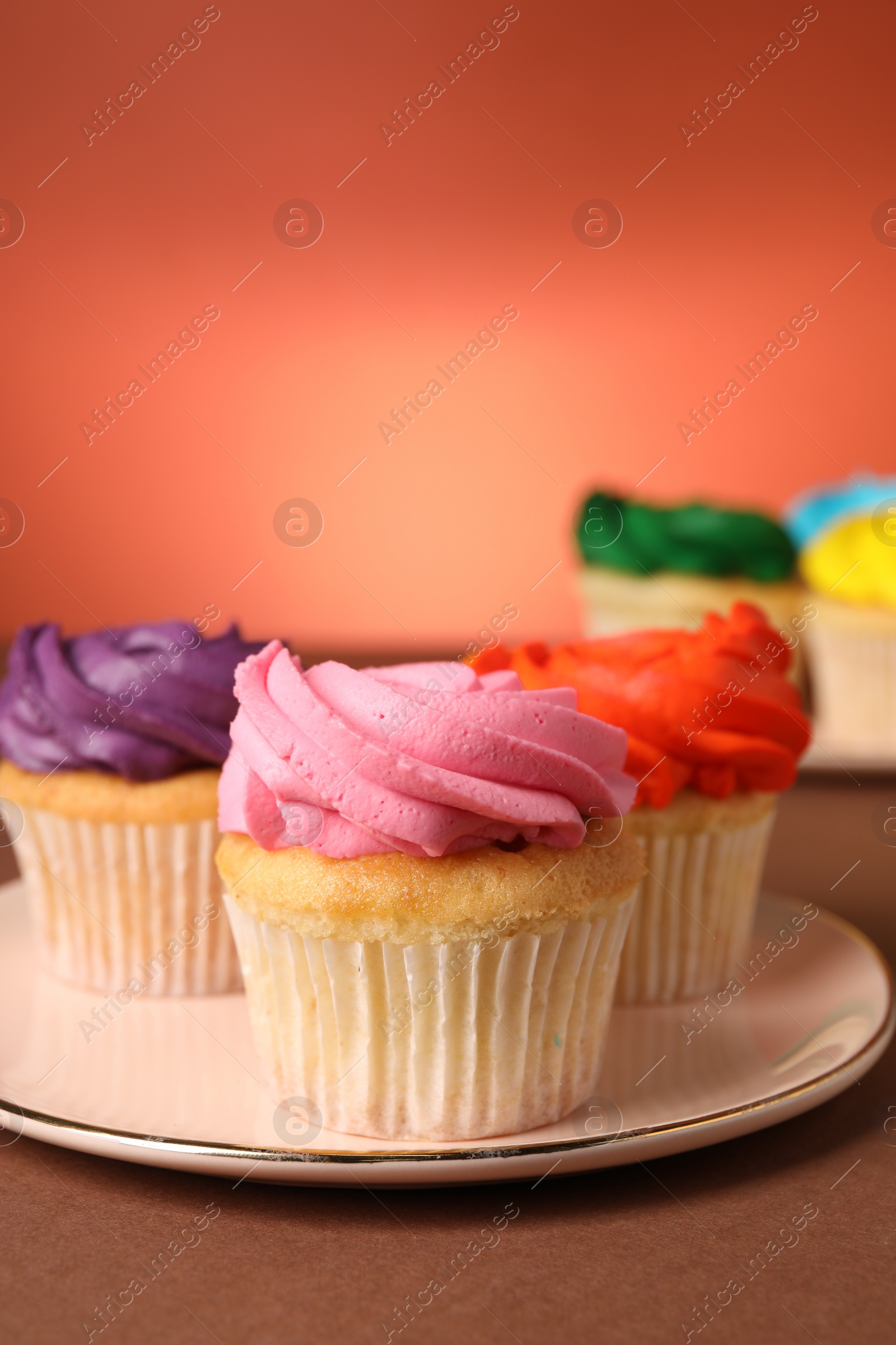 Photo of Delicious cupcakes with bright cream on color background, space for text