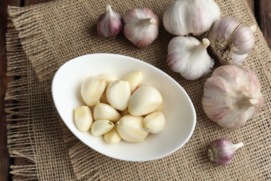 Fresh garlic bulbs and cloves on table, flat lay