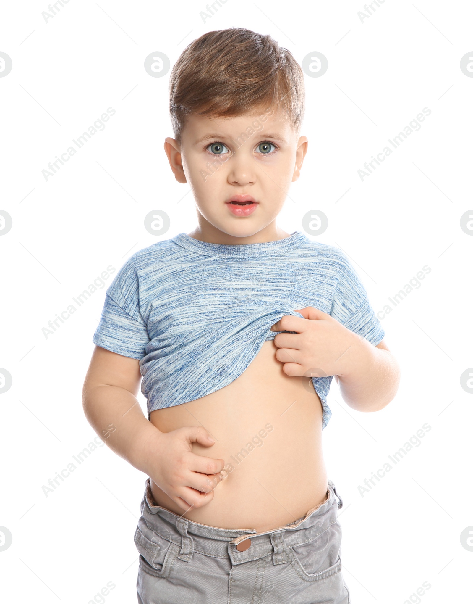 Photo of Little boy scratching belly on white background. Annoying itch