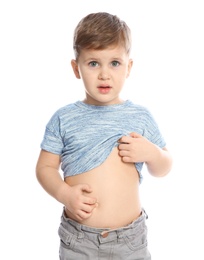 Little boy scratching belly on white background. Annoying itch