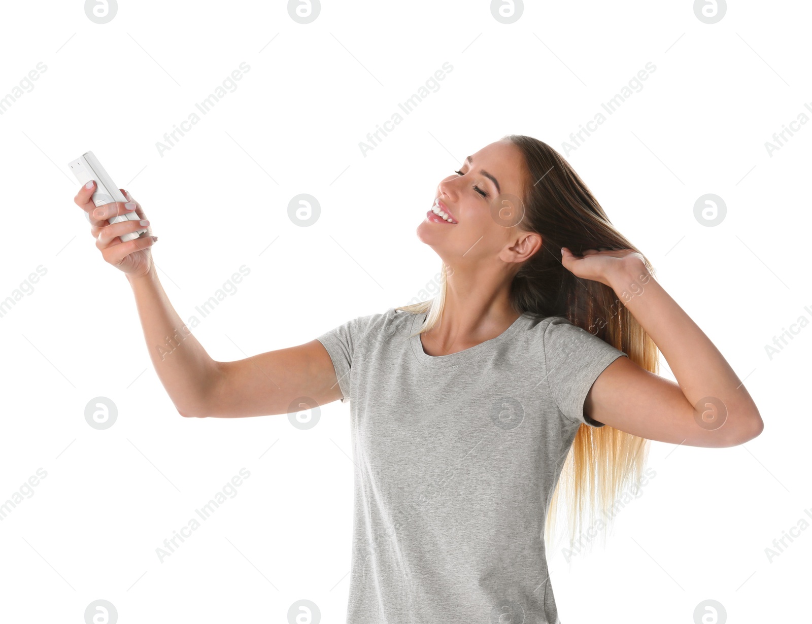 Photo of Young woman with air conditioner remote on white background