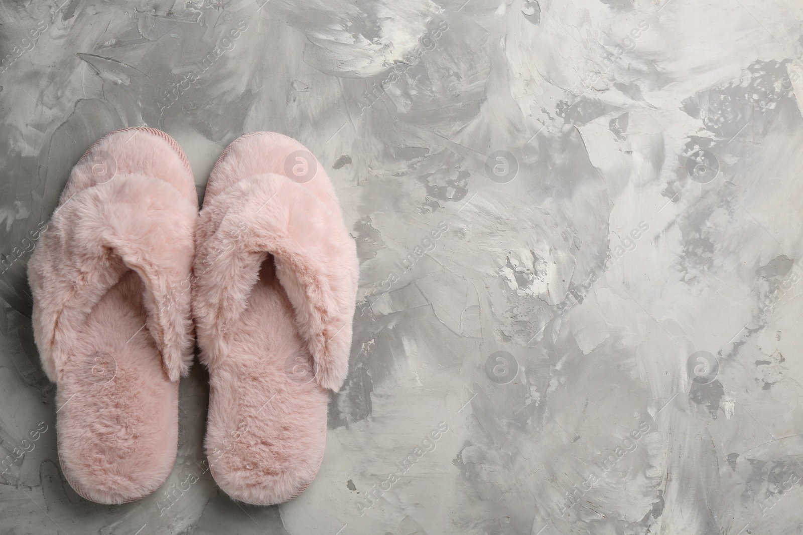Photo of Pair of stylish soft slippers on grey background, flat lay. Space for text