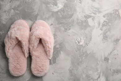 Pair of stylish soft slippers on grey background, flat lay. Space for text