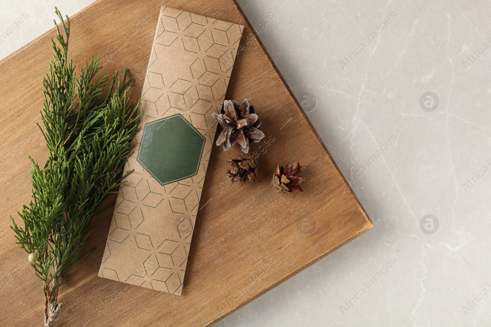 Photo of Scented sachet, pine cones and fir branch on grey table, top view