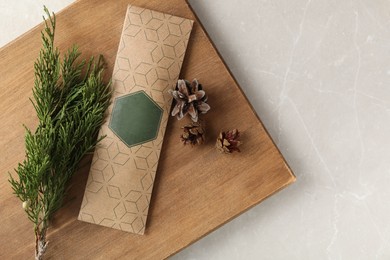 Photo of Scented sachet, pine cones and fir branch on grey table, top view