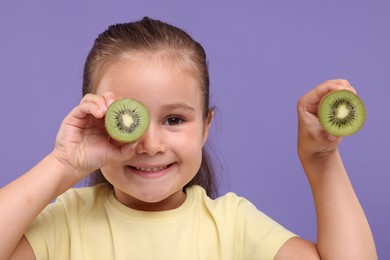 Photo of Smiling girl with fresh kiwi on violet background