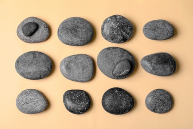 Spa stones on color background, flat lay