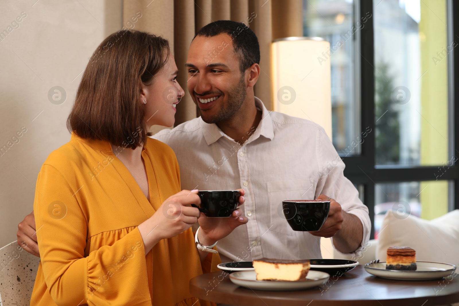 Photo of Romantic date. Happy couple spending time together in cafe