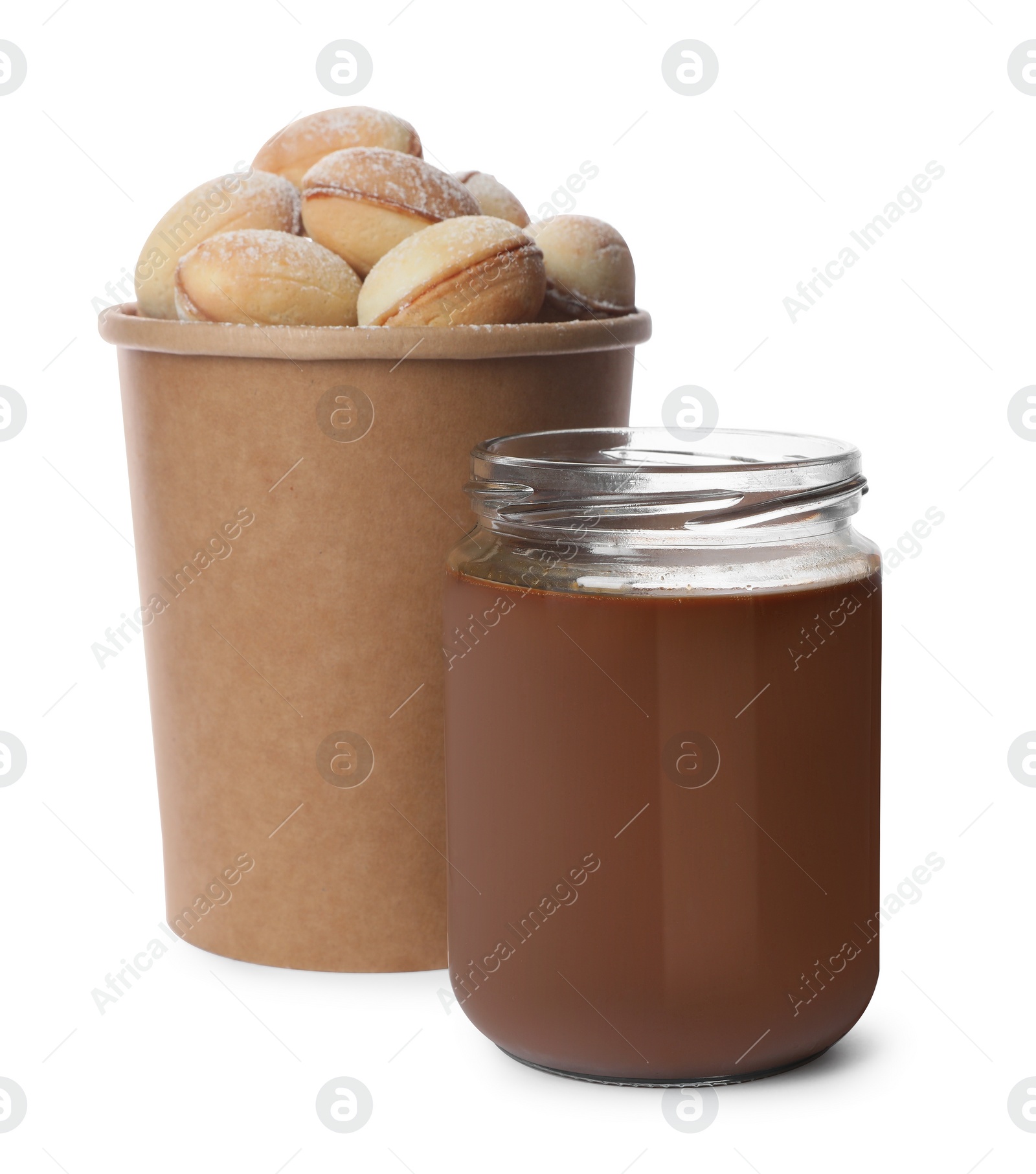 Photo of Jar with boiled condensed milk and walnut shaped cookies on white background