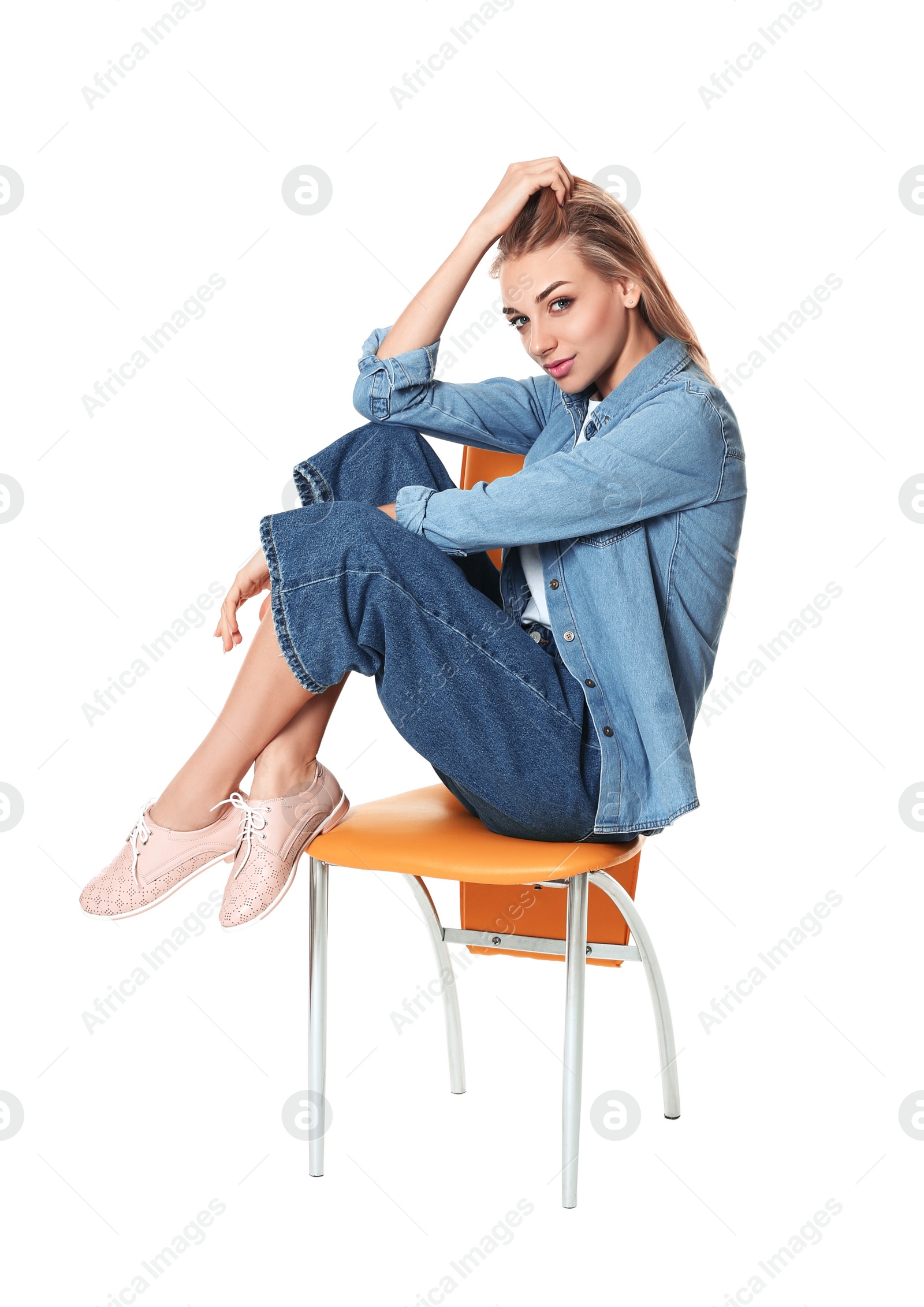 Photo of Fashionable woman in stylish shoes on chair against white background