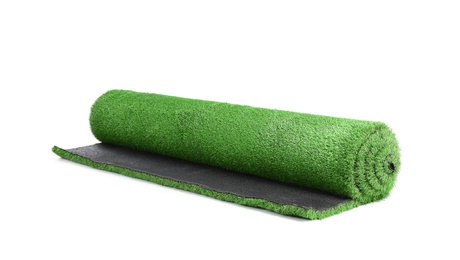 Photo of Rolled artificial grass carpet on white background. Exterior element