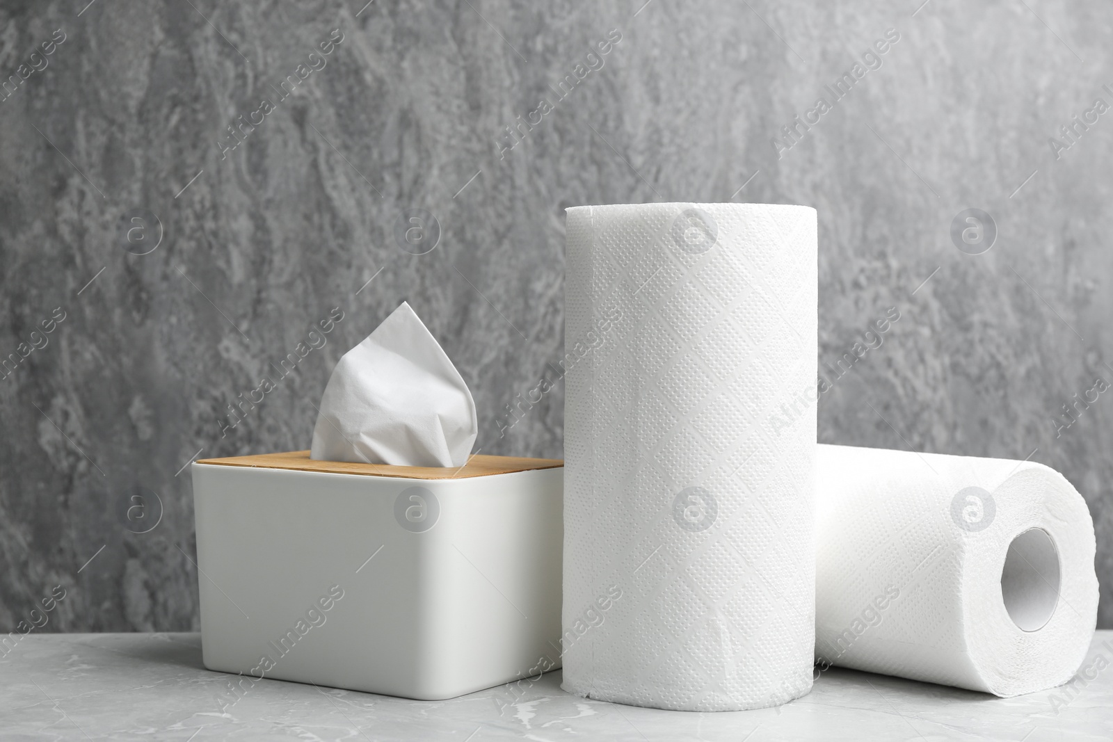 Photo of Rolls of paper towels and tissues on marble table