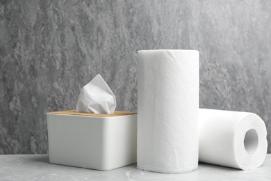 Photo of Rolls of paper towels and tissues on marble table