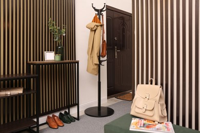 Modern hallway interior with console table and clothes rack