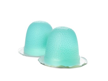 Photo of Delicious light blue jelly cups on white background