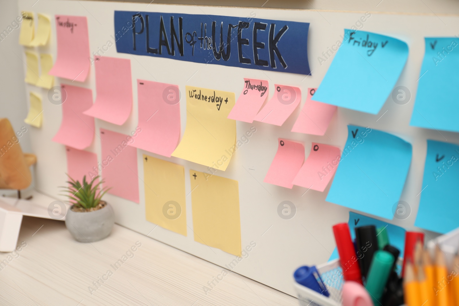 Photo of Business process planning and optimization. Workplace with colorful paper notes and other stationery on table, closeup