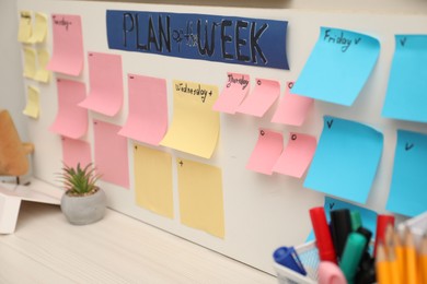 Business process planning and optimization. Workplace with colorful paper notes and other stationery on table, closeup