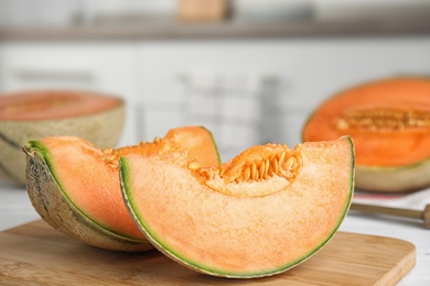Photo of Slices of ripe cantaloupe melon on white wooden table