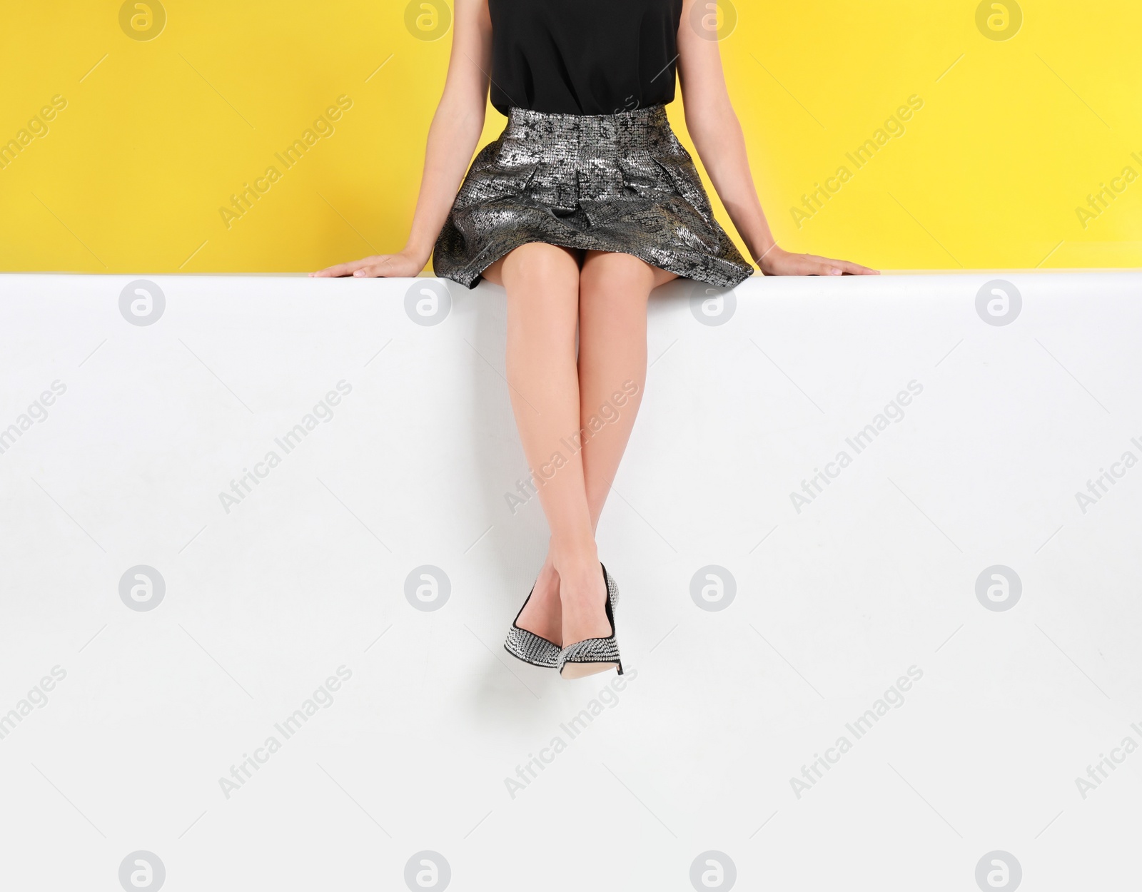 Photo of Woman wearing stylish shoes on color background, closeup