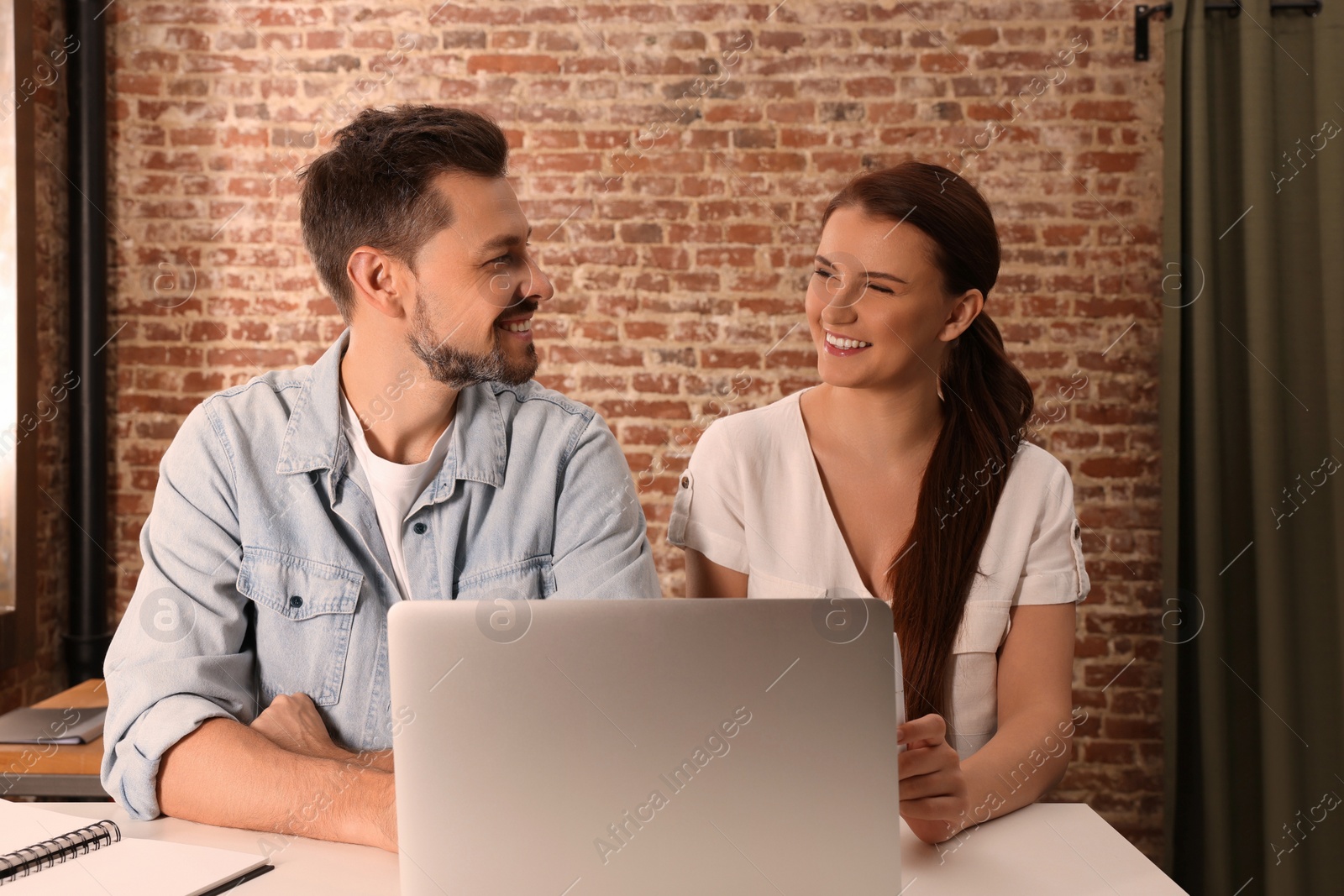 Photo of Team of employees working together in office