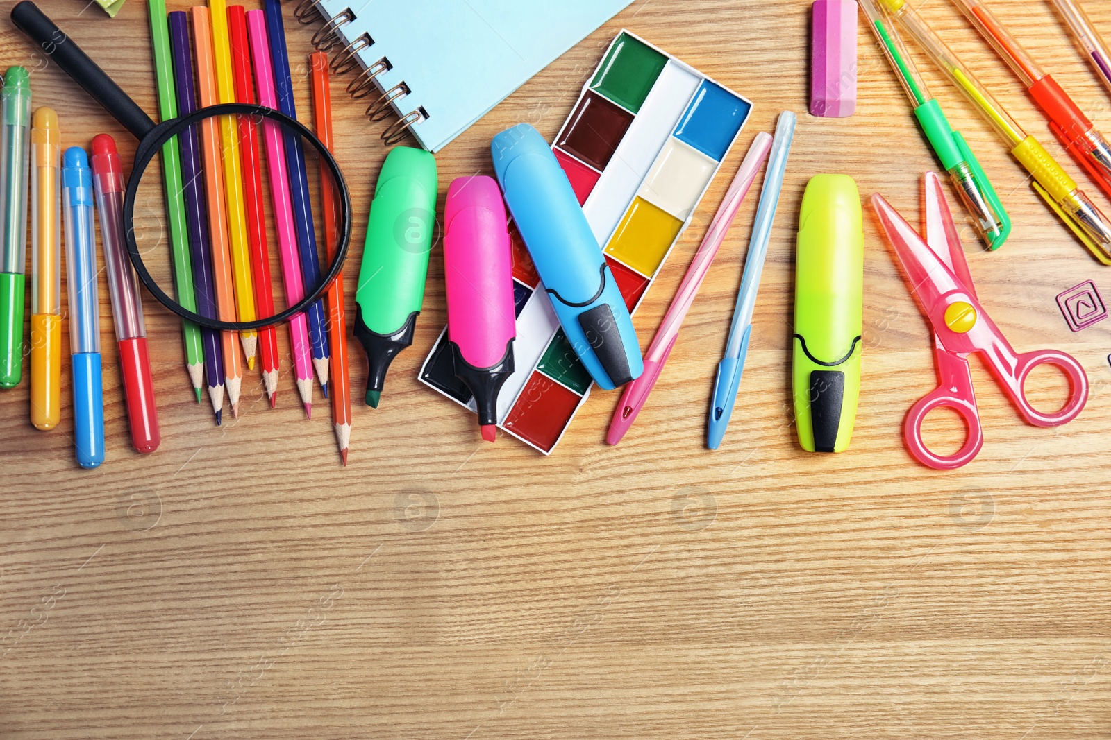 Photo of Different school stationery with space for design on wooden background, flat lay