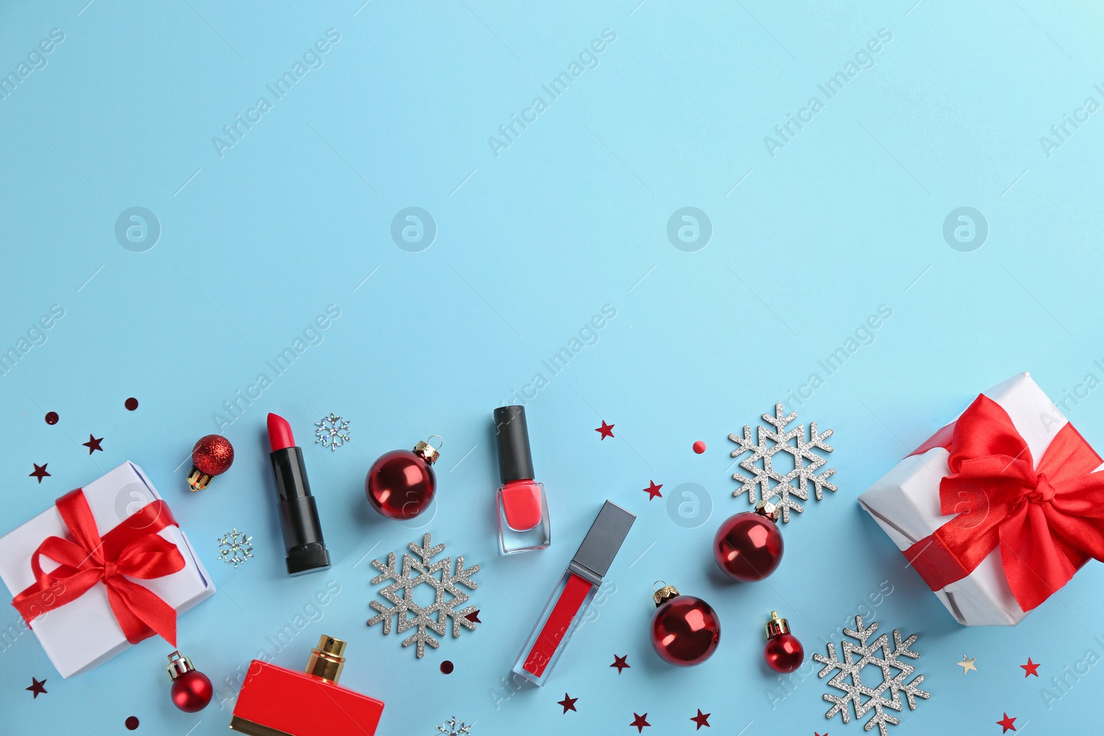 Photo of Flat lay composition with decorative cosmetic products on light blue background, space for text. Winter care