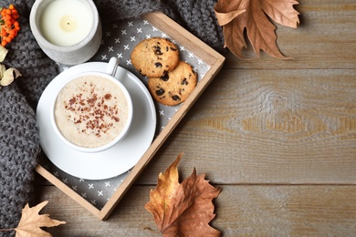 Photo of Flat lay composition with cup of hot drink on wooden table, space for text. Cozy autumn atmosphere