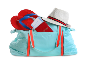 Stylish bag with hat, flip-flops and passport on white background