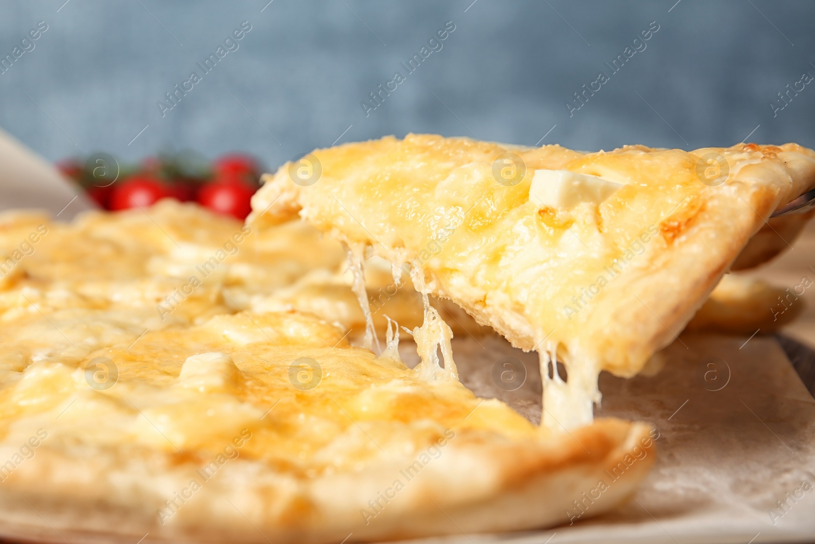 Photo of Taking tasty homemade pizza slice with melted cheese, closeup