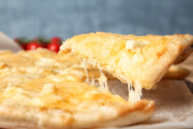 Taking tasty homemade pizza slice with melted cheese, closeup