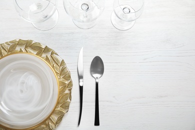 Elegant table setting with space for text on light background, top view