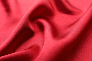 Texture of beautiful red silk fabric as background, closeup