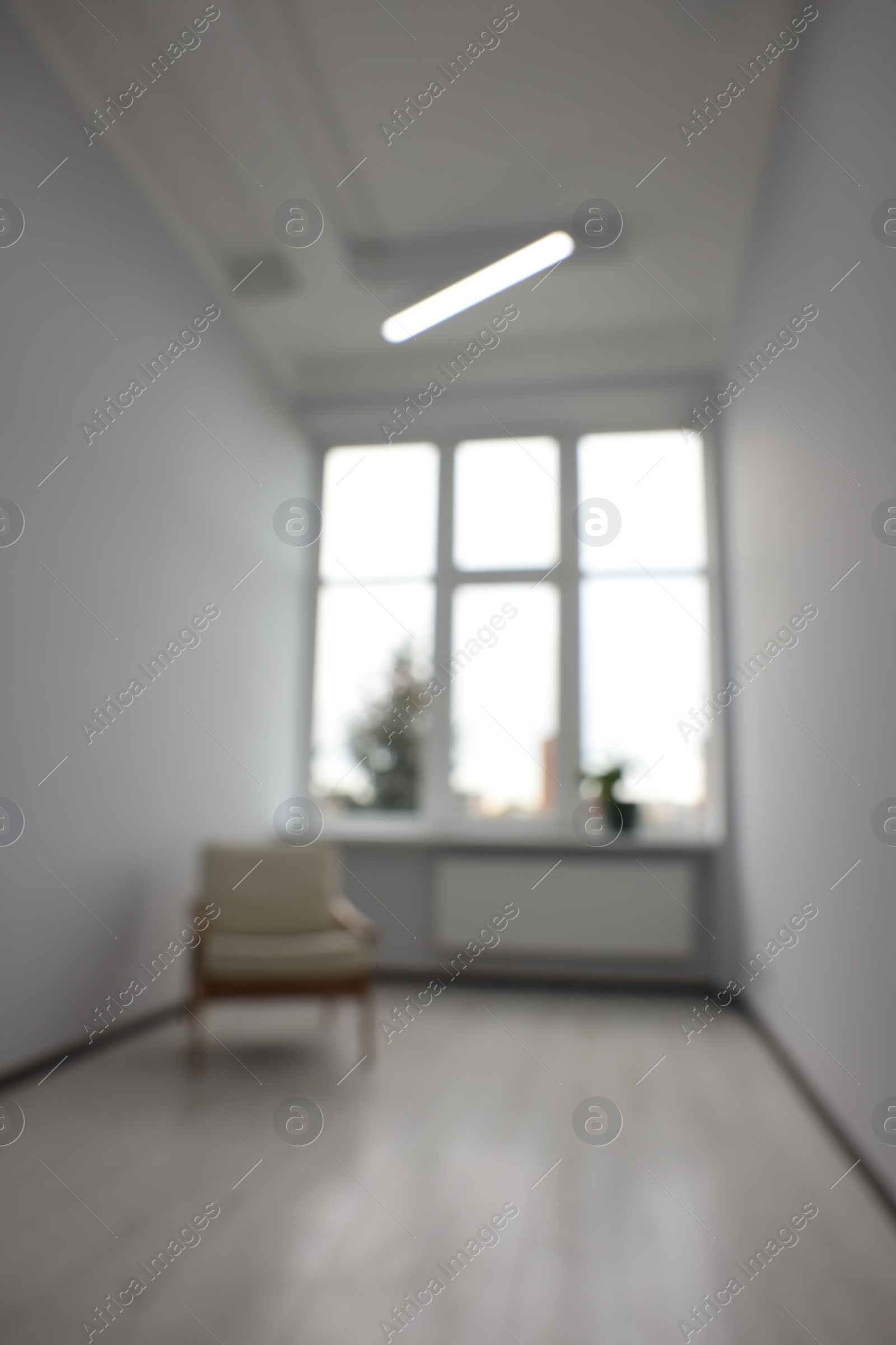 Photo of Blurred view of new empty room with windows