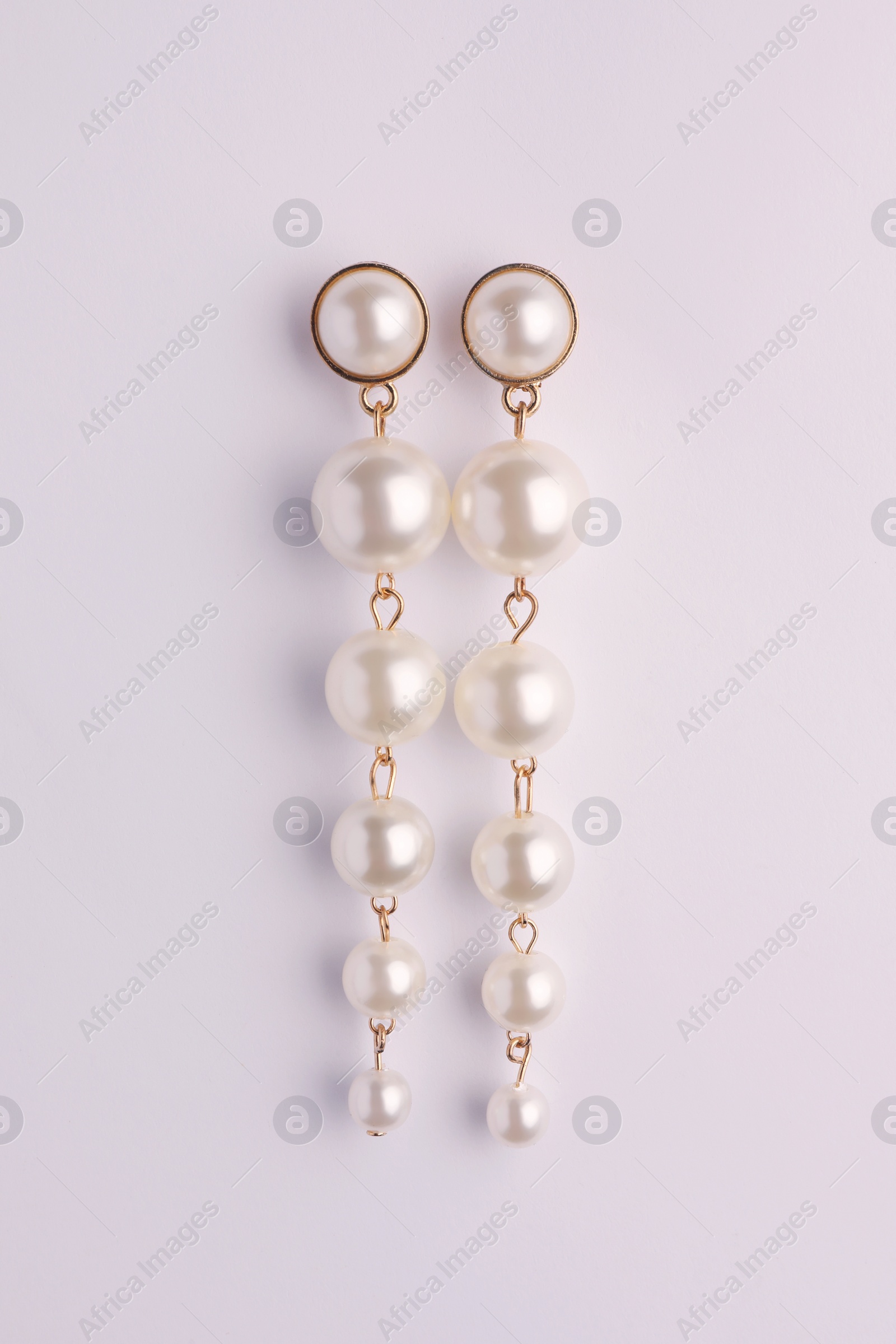 Photo of Elegant pearl earrings isolated on white, top view