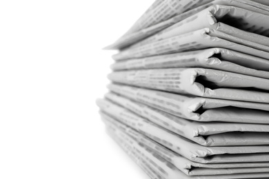 Photo of Stack of newspapers on white background, closeup. Journalist's work