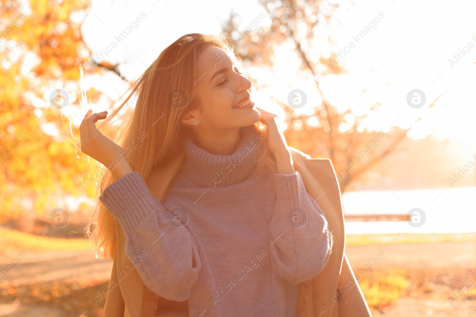 Photo of Beautiful young woman wearing stylish clothes in autumn park