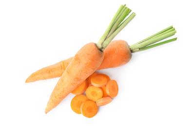 Whole and cut ripe carrots isolated on white, top view