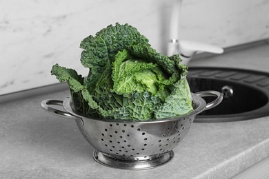 Photo of Fresh green savoy cabbage on grey table