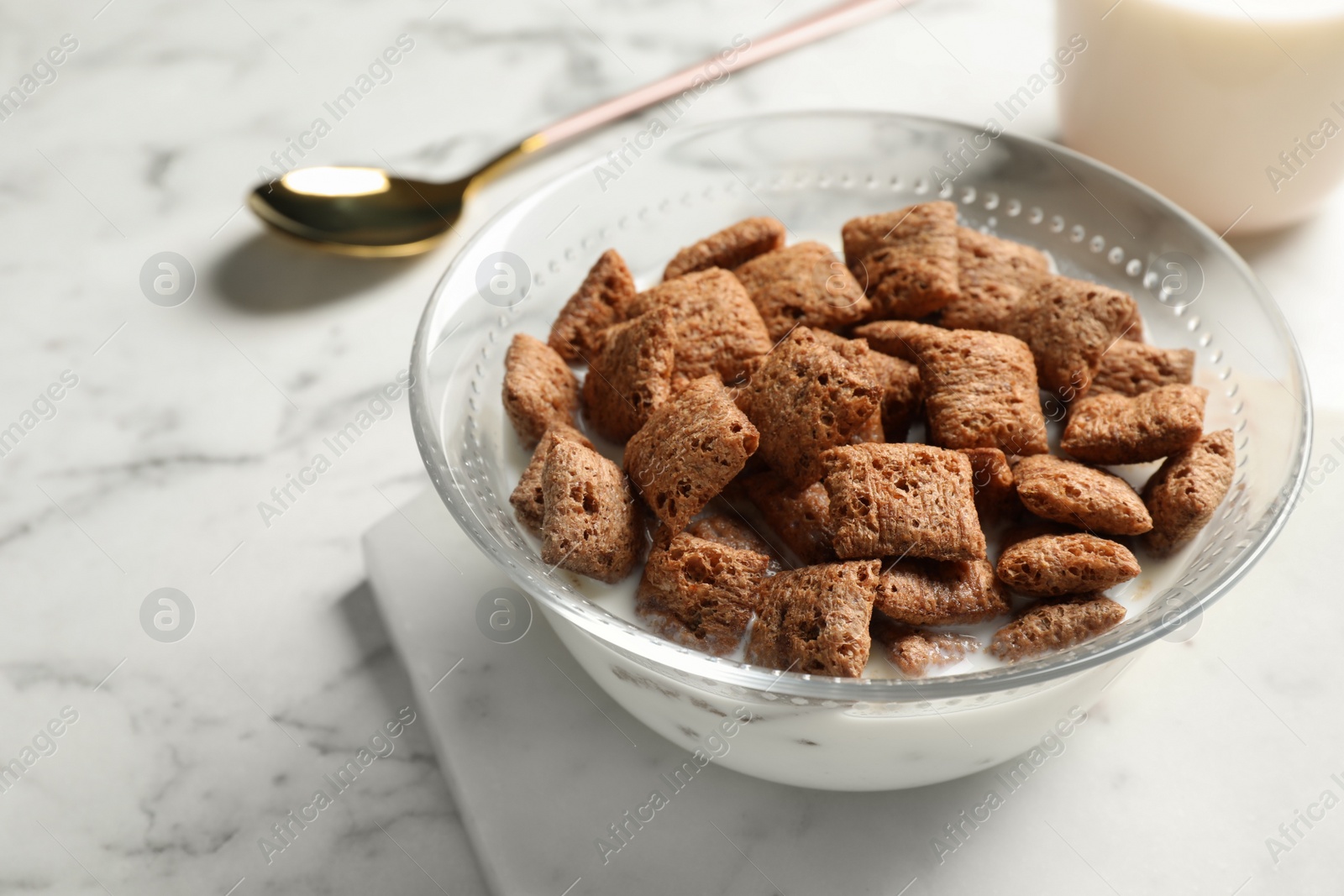 Photo of Tasty corn pads with milk served for breakfast on white marble table, closeup